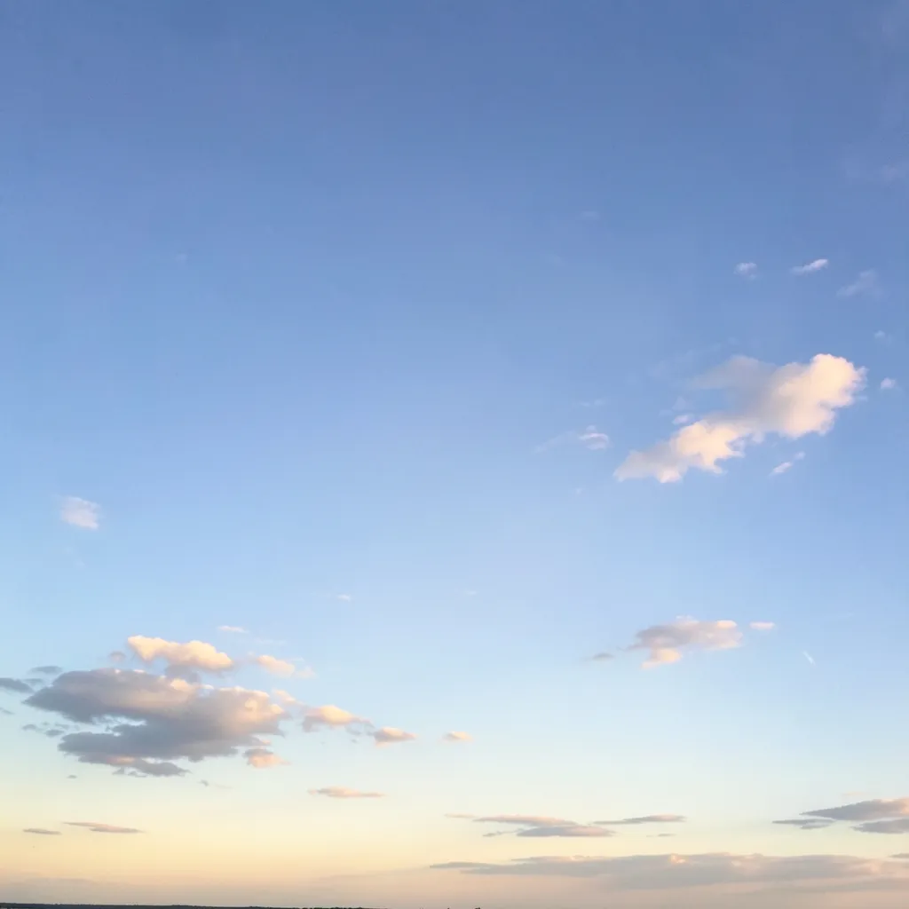 The Retrograde Pause: Navigating Life's Cosmic Shifts Serene sky with a few scattered clouds, with a subtle glow emanating from the horizon — Stop stressing over the retrogrades